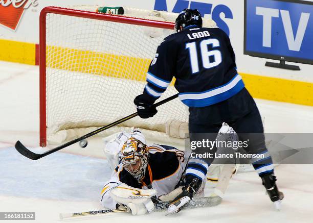 Andrew Ladd of the Winnipeg Jets dekes out goaltender Ryan Miller of the Buffalo Sabres for a second period goal at the MTS Centre on April 9, 2013...