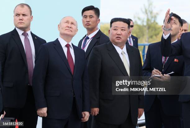 In this pool photo distributed by Sputnik agency, Russia's President Vladimir Putin and North Korea's leader Kim Jong Un visit the Vostochny...