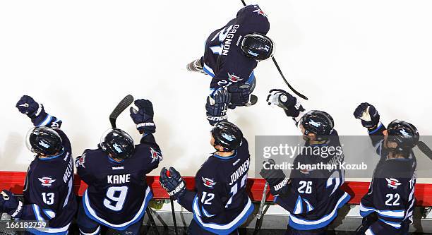 Aaron Gagnon of the Winnipeg Jets is congratulated by teammates on the bench following his first career NHL goal in the second period against the...