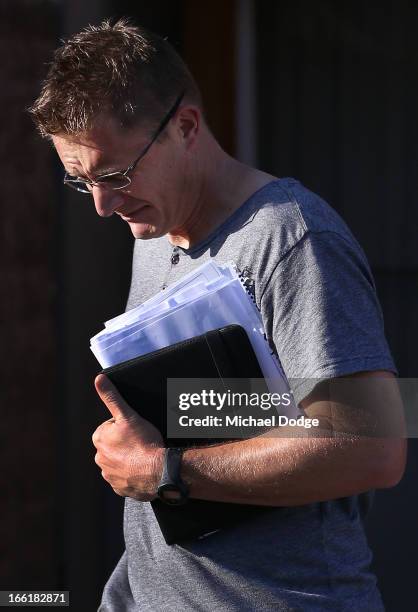 Demons coach Mark Neeld is seen walking from his hotel room during a camp for Melbourne Demons AFL players and coaching staff at Sorrento on April...