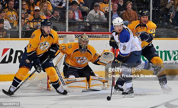 Jaden Schwartz of the St Louis Blues fights for position against Chris Mueller, goalie Pekka Rinne and Hal Gill of the Nashville Predators at the...