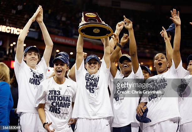 Kelly Faris of the Connecticut Huskies holds up the National Championship Trophy with her teammates after defeating the Louisville Cardinals during...