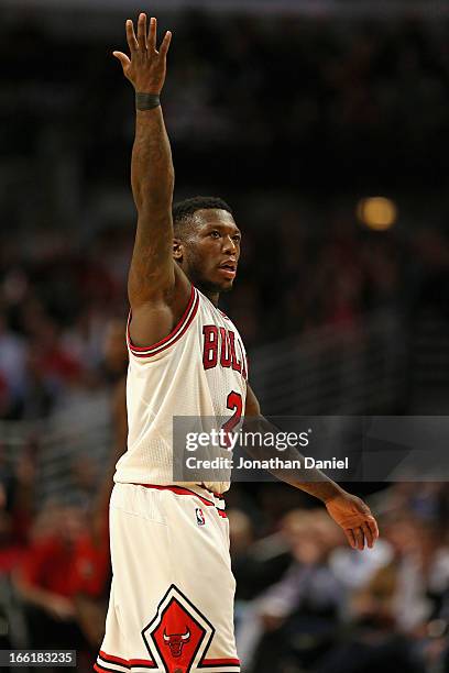 Nate Robinson of the Chicago Bulls encourages the crowd to cheer during a game against the Toronto Raptors at the United Center on April 9, 2013 in...