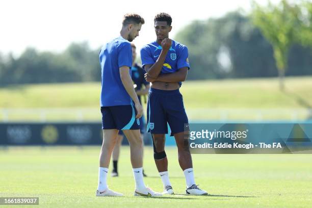 Jordan Henderson and Jude Bellingham of England talk during a training session at St George's Park on September 05, 2023 in Burton upon Trent,...