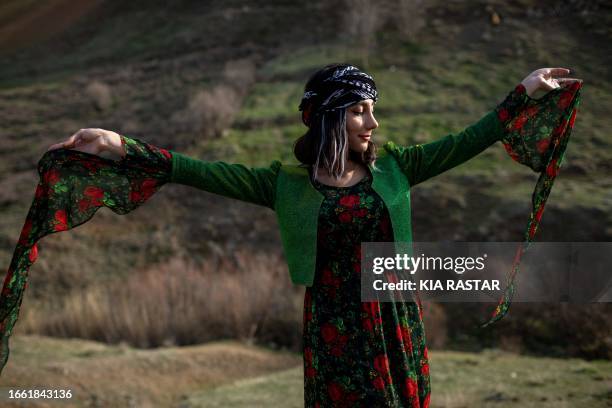 Kurdistan, Iran. A young Iranian Kurdish girl, dressed in vibrant and colorful Kurdish attire, celebrates the arrival of Nowruz, the Persian New...