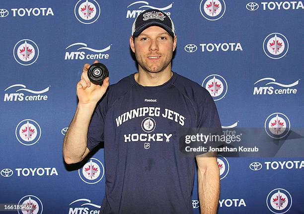 Aaron Gagnon of the Winnipeg Jets shows off the puck used in his first career NHL goal during NHL action against the Buffalo Sabres at the MTS Centre...