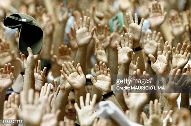 Thousands of employees of the Sao Paulo State Bank protest raising their arms in a center street of the Sao Paulo financial district, Brazil, 01...