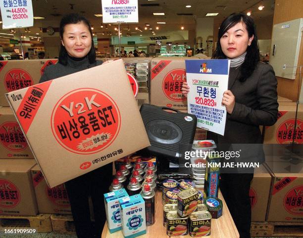 Employees at Hawha Mart, a large-scale supermarket in Seoul, 30 November 1999, display Y2K emergency kits prepared for possible disasters that may be...