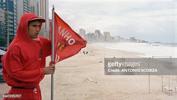 Lifeguard in Rio de Janeiro raisesa red flag 31 May 1999 to indicate that the beaches of Rio have not yet reopened after a sewage leak closed them...