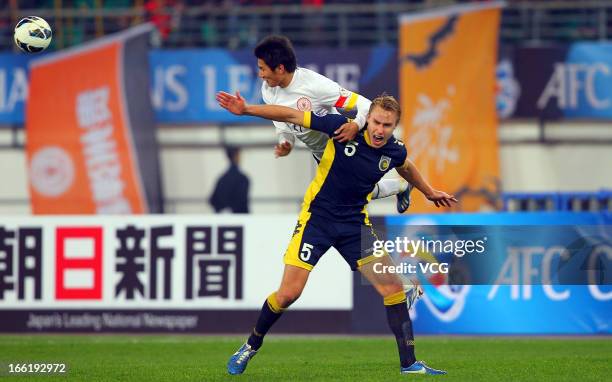 Zachary Anderson of Central Coast Mariners and Yu Hai of Guizhou Renhe battle for the ball during the AFC Champions League match between Guizhou...