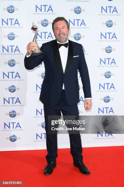 Lee Mack, accepting the Best Quiz Show award on behalf of "The 1% Club", poses in the press room at the National Television Awards 2023 at The O2...