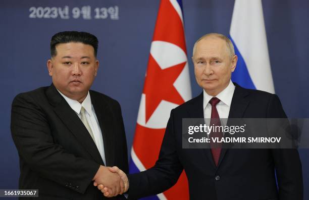 This pool image distributed by Sputnik agency shows Russian President Vladimir Putin and North Korea's leader Kim Jong Un shaking hands during their...