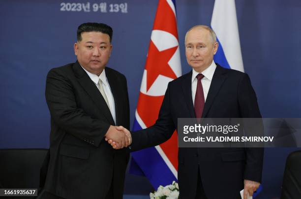 This pool image distributed by Sputnik agency shows Russian President Vladimir Putin and North Korea's leader Kim Jong Un shaking hands during their...