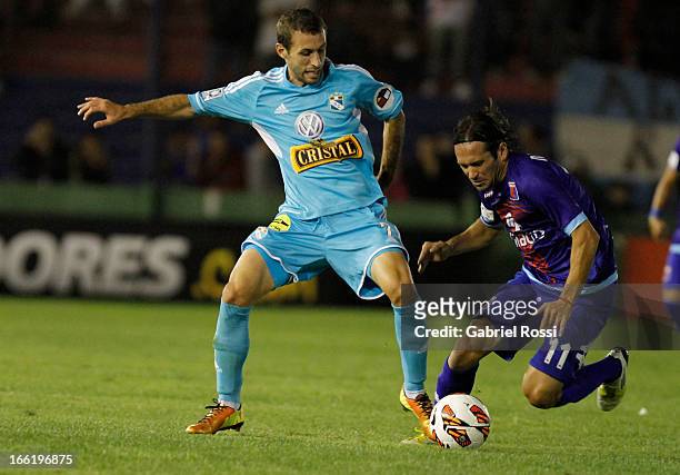 Horacio Calcaterra of Sporting Cristal fights for the ball with Ramiro Leone of Club Atletico Tigre during the match between Club Atletico Tigre and...