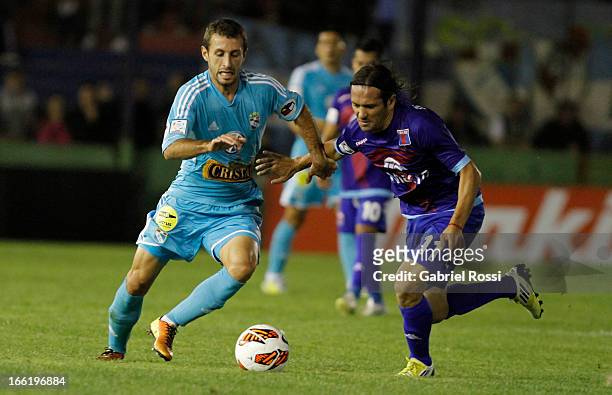 Horacio Calcaterra of Sporting Cristal fights for the ball with Ramiro Leone of Club Atletico Tigre during the match between Club Atletico Tigre and...