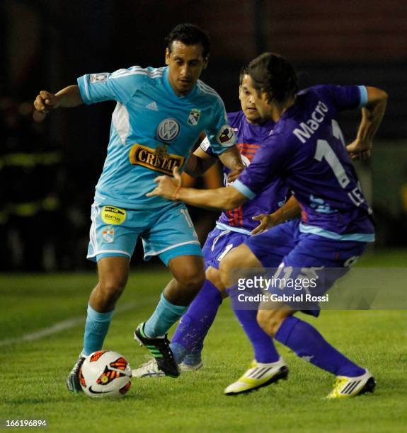 Avila of Sporting Cristal fights for the ball with Ramiro Leone of Club Atletico Tigre during the match between Club Atletico Tigre and Sporting...