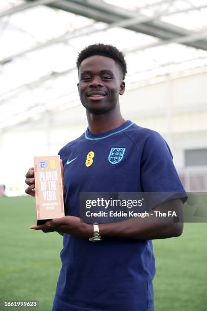 Bukayo Saka of England poses for a photograph holding the England 'Player of the Year' award at St George's Park on September 05, 2023 in Burton upon...