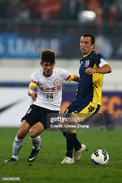 John Hutchinson of the Mariners challenges Yang yihu of Guizhou Renhe during the AFC Champions League match between Guizhou Renhe and Central Coast...