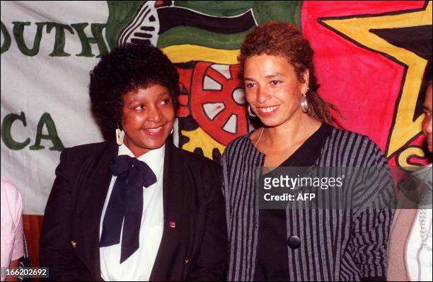Veteran US militant Angela Davis is met 30 August 1991 by anti-apartheid campaigner Winnie Mandela, wife of anti-apartheid activist Nelson Mandela,...