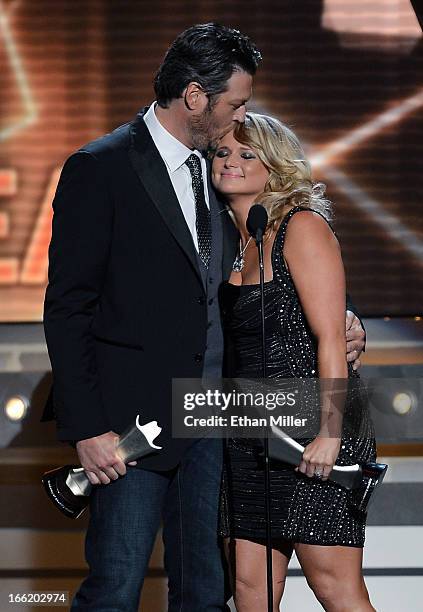 Recording artist Blake Shelton kisses his wife, recording artist Miranda Lambert, as they accept the award for Song of the Year for "Over You" during...