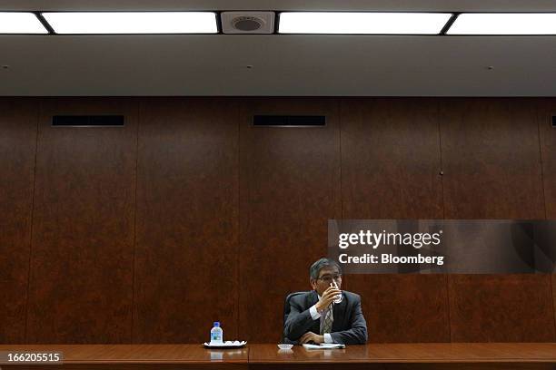 Haruhiko Kuroda, governor of the Bank of Japan , takes a drink of water during a group interview at the central bank's headquarters in Tokyo, Japan,...