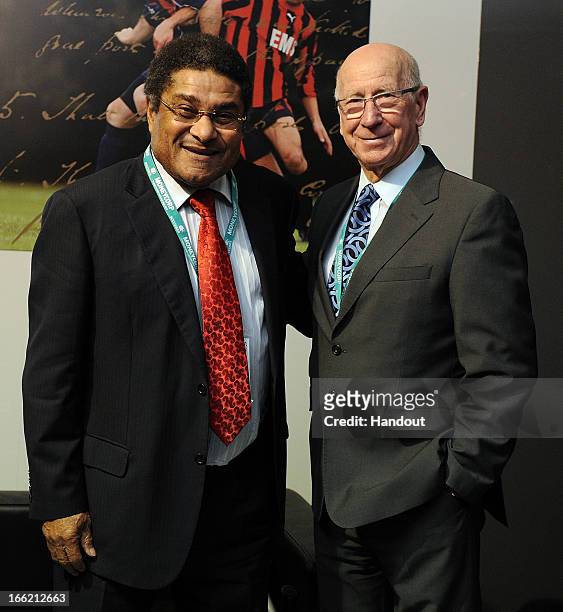 In this handout image provided by The FA, Eusebio and Sir Bobby Charlton pose for a photograph in the FA150 lounge during the Soccerex European Forum...