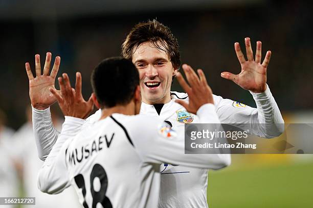 Fozil Musaev of Bunyodkor celebrates scoring his team's first goal with team mate Oleg Zoteev during the AFC Champions League Group match between...