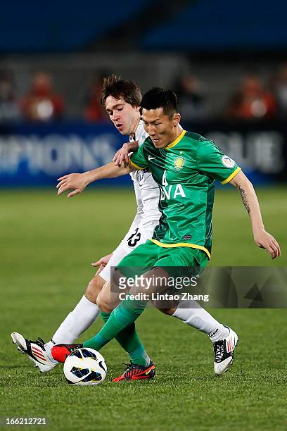 Oleg Zoteev of Bunyodkor challenges Zhou Ting of Beijing Guoan during the AFC Champions League Group match between Bunyodkor and Beijing Guoan at...