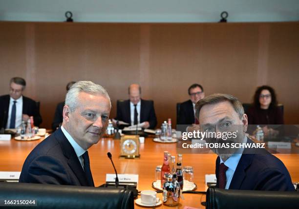 France's Economy Minister Bruno Le Maire and German Finance Minister Christian Lindner look on prior to the start of a weekly cabinet meeting at the...