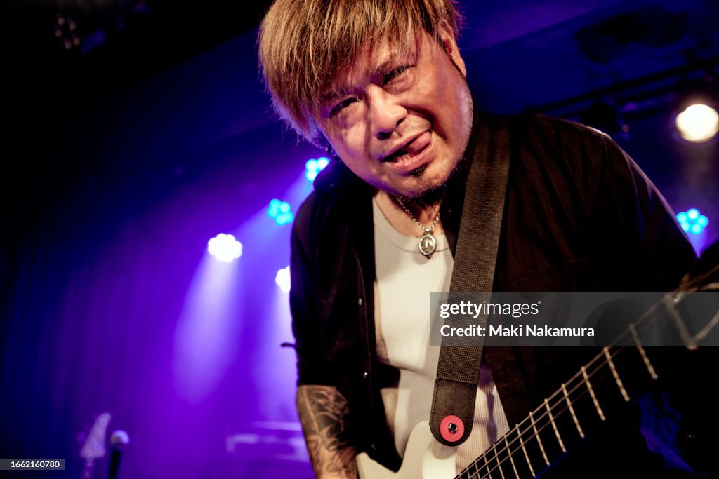 Guitarist performing on stage at music concert