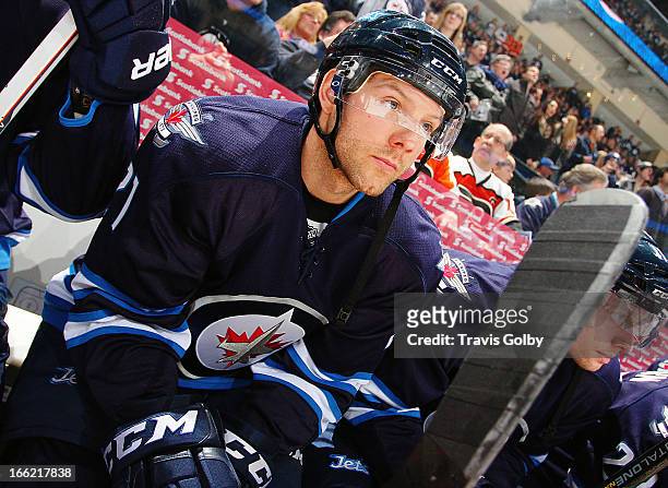Aaron Gagnon of the Winnipeg Jets looks on from the bench prior to puck drop against the Philadelphia Flyers at the MTS Centre on April 6, 2013 in...