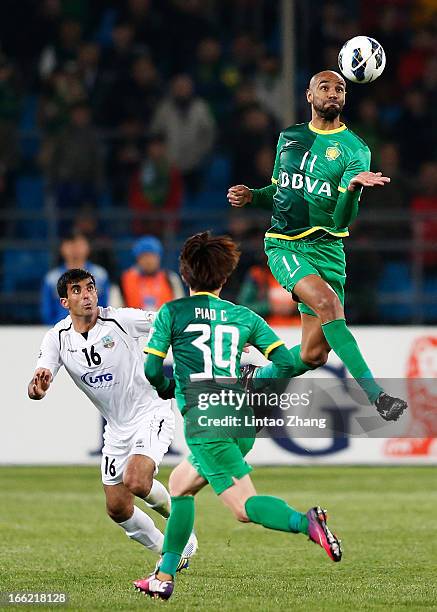 Frederic Kanoute of Beijing Guoan competes for an aerial ball with Artyom Filiposyan of Bunyodkor during the AFC Champions League Group match between...