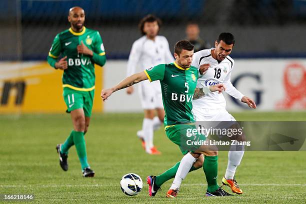 Fozil Musaev of Bunyodkor challenges Matic Darko of Beijing Guoan during the AFC Champions League Group match between Bunyodkor and Beijing Guoan at...