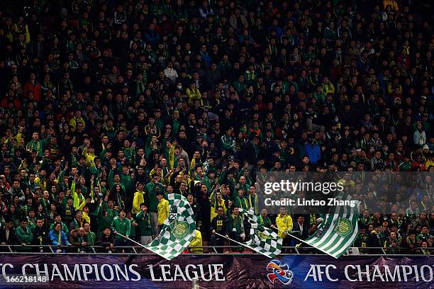 Beijing Guoan fans support their team during the AFC Champions League Group match between Bunyodkor and Beijing Guoan at Beijing Workers' Stadium on...