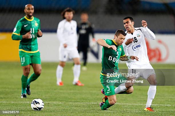 Fozil Musaev of Bunyodkor challenges Matic Darko of Beijing Guoan during the AFC Champions League Group match between Bunyodkor and Beijing Guoan at...