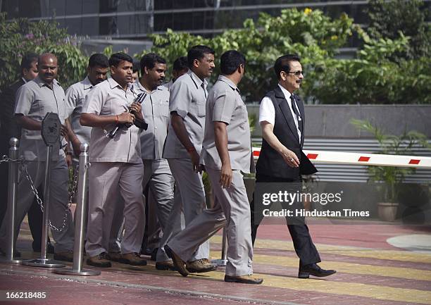 Sahara Group Chairman Subrata Roy accompanied by his security leaves the Securities and Exchange Board of India headquarters on April 8, 2013 in...