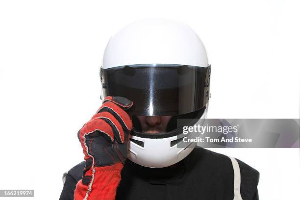 racing driver lifts open helmet visor - racing suit stock pictures, royalty-free photos & images