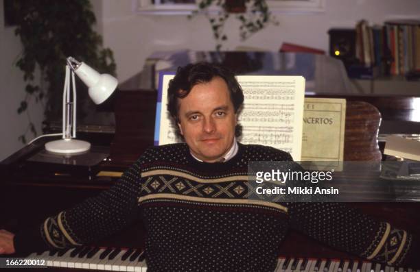 American film score composer Richard Robbins sitting at a piano in his studio, Cambridge, Massachussetts, October 1981.