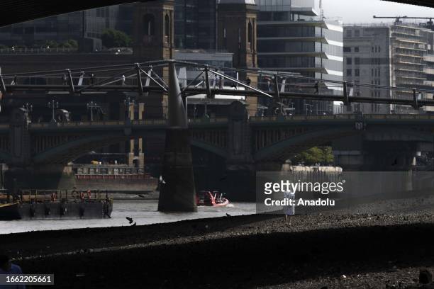 View of the Thames River bed after the water retreats in London, United Kingdom on September 11, 2023. For centuries, people have been upholding the...
