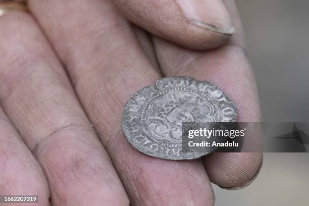 Man shows an object he unearthed from the Thames River bed after the water retreats in London, United Kingdom on September 11, 2023. For centuries,...