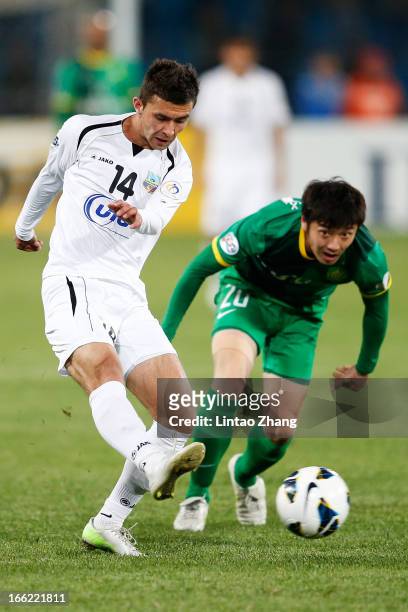 Alibobo Rakhmatullaev of Bunyodkor challenges Zhang Xinxin of Beijing Guoan during the AFC Champions League Group match between Bunyodkor and Beijing...