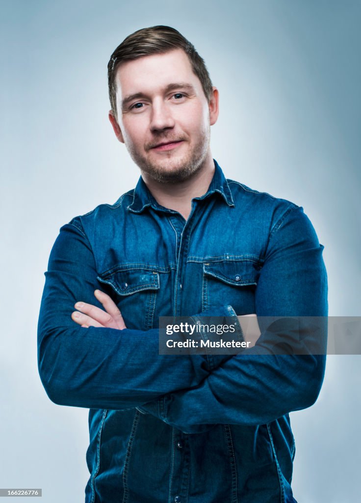 Confident young man with crossed arms