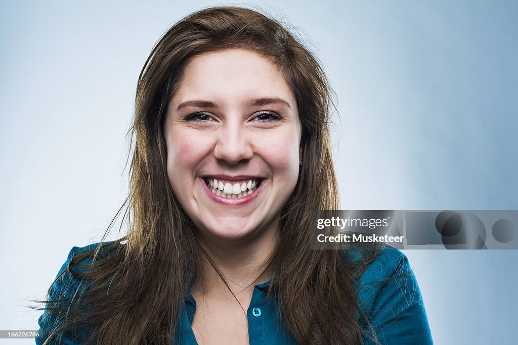 Attractive young woman looking into camera smiling