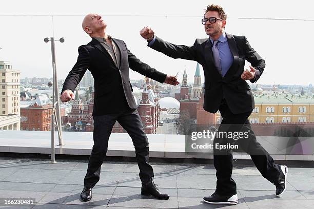 Actors Robert Downey Jr. And Sir Ben Kingsley pose during a photocall on the roof of Ritz Carlston hotel for Russia Tour for 'Iron Man 3' on April...