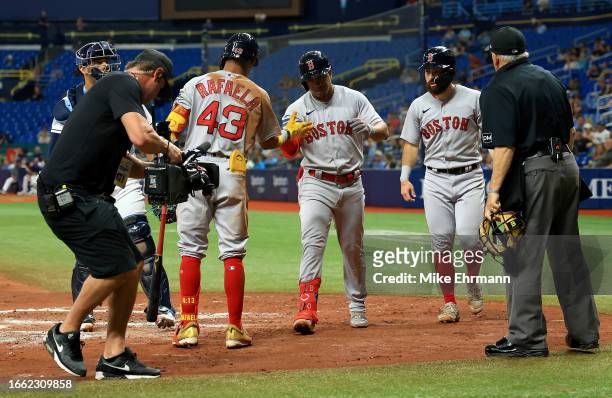 Enmanuel Valdez of the Boston Red Sox is congratulated after hitting a two run home run in the third inning during a game against the Tampa Bay Rays...