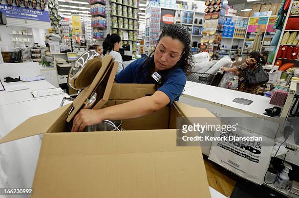 Store managerJeannie Archila packs up a cookware at a Bed Bath & Beyond store on April 10, 2013 in Los Angeles, California. The home goods retailer...