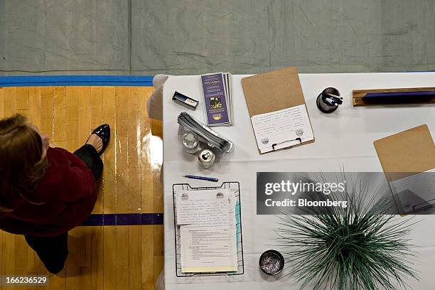 Company representative walks near an employer table during a job fair at Illinois Valley Community College in Oglesby, Illinois, U.S., on Wednesday,...