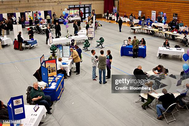 Job seekers mingle with employers during a job fair at Illinois Valley Community College in Oglesby, Illinois, U.S., on Wednesday, April 10, 2013....