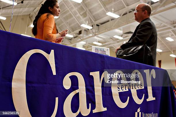 Job seeker, right, talks with an Illinois Valley Community College career services advisor during a job fair in Oglesby, Illinois, U.S., on...