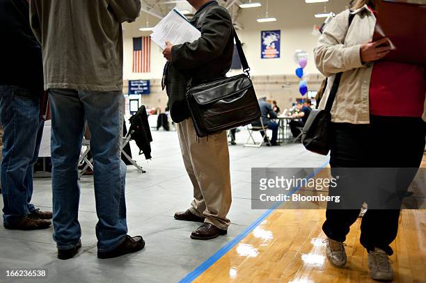 Job seekers mingle with employers during a job fair at Illinois Valley Community College in Oglesby, Illinois, U.S., on Wednesday, April 10, 2013....